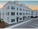 Modern three-story townhome with white brick facade and clean lines at 1218 E Kay St # 11, Tampa, FL 33602