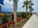 Community playground with a fence, mature trees, lush landscaping and colorful flowers at 7002 162Nd E Pl, Parrish, FL 34219
