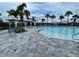 Community pool with plenty of lounge chairs for everyone, covered gazebo and mature palm trees at 7002 162Nd E Pl, Parrish, FL 34219
