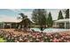 Community pool and recreation center surrounded by vibrant flowers and lounge chairs at 7002 162Nd E Pl, Parrish, FL 34219