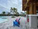 Community pool with plenty of lounge chairs for everyone, covered gazebo and mature palm trees at 7002 162Nd E Pl, Parrish, FL 34219