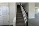 Modern staircase with white railing and black accents, leading to upper level at 7002 162Nd E Pl, Parrish, FL 34219