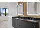 Double vanity with black cabinets and marble countertops at 1907 W Grace St, Tampa, FL 33607