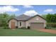 One-story home with a terracotta roof and landscaped yard at 12724 Tahitian Pearl Cir, Parrish, FL 34219