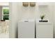 Laundry room with washer, dryer, and overhead shelving at 12724 Tahitian Pearl Cir, Parrish, FL 34219