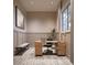 Bright home office features a wood desk, comfortable chair, and built-in bench at 12724 Tahitian Pearl Cir, Parrish, FL 34219