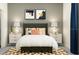 Cozy bedroom with a gray headboard and stylish decor at 12724 Tahitian Pearl Cir, Parrish, FL 34219