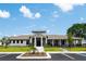 Community clubhouse with welcoming exterior and landscaping at 6418 Back Forty Loop, Zephyrhills, FL 33541