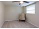 Small bedroom with a comfortable armchair and large window at 12945 Morris Bridge Rd, Thonotosassa, FL 33592