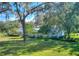 House exterior showcasing light blue siding and a spacious lawn at 12945 Morris Bridge Rd, Thonotosassa, FL 33592