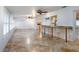 Large living area with tile flooring and ceiling fans at 12945 Morris Bridge Rd, Thonotosassa, FL 33592