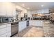 Bright kitchen with granite countertops, stainless steel appliances, and white cabinets at 12945 Morris Bridge Rd, Thonotosassa, FL 33592