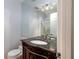 Bathroom with granite vanity and a large mirror at 12945 Morris Bridge Rd, Thonotosassa, FL 33592