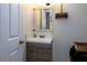 Clean bathroom with a vanity, mirror, and shelf at 12945 Morris Bridge Rd, Thonotosassa, FL 33592