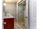 Bathroom with glass shower, granite countertop and modern vanity at 12945 Morris Bridge Rd, Thonotosassa, FL 33592