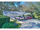 Three-car garage with ample parking space and well-maintained landscaping at 12945 Morris Bridge Rd, Thonotosassa, FL 33592