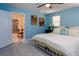 Bedroom with king-size bed, ceiling fan, and access to another room at 12945 Morris Bridge Rd, Thonotosassa, FL 33592
