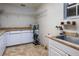 Laundry room with utility sink and ample shelving at 12945 Morris Bridge Rd, Thonotosassa, FL 33592