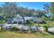 House exterior showcasing a large driveway, three-car garage, and landscaping at 12945 Morris Bridge Rd, Thonotosassa, FL 33592