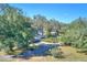 Aerial view showing a single-story home on a large lot with mature trees at 12945 Morris Bridge Rd, Thonotosassa, FL 33592