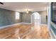 Bright living room with hardwood floors and an arched doorway at 12945 Morris Bridge Rd, Thonotosassa, FL 33592