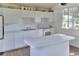 Bright kitchen featuring white cabinets and an island at 12945 Morris Bridge Rd, Thonotosassa, FL 33592