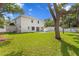 Expansive backyard showcasing lush green grass and a modern home design with a pool and ample space at 4005 W San Rafael St, Tampa, FL 33629