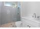 Bathroom featuring walk-in shower with blue subway tiles and white vanity at 4005 W San Rafael St, Tampa, FL 33629