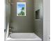 Bright bath area has tub, shower with view at 4005 W San Rafael St, Tampa, FL 33629
