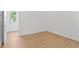 Empty bedroom with hardwood floor and a doorway to the hallway and closet at 4005 W San Rafael St, Tampa, FL 33629