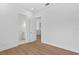 Bright bedroom featuring hardwood floors, white walls, and ensuite bathroom at 4005 W San Rafael St, Tampa, FL 33629