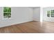 Well-lit bedroom with wood flooring and ample natural light from two large windows at 4005 W San Rafael St, Tampa, FL 33629