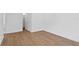 Bright room features wood flooring, white walls and trim, with view to walk-in closet at 4005 W San Rafael St, Tampa, FL 33629