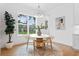Dining room with natural light, neutral tones, a round table, and hardwood floors at 4005 W San Rafael St, Tampa, FL 33629