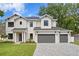 Beautiful two story home with three car garage, lovely landscaping, and modern design at 4005 W San Rafael St, Tampa, FL 33629