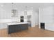Modern kitchen with custom white cabinets, gray island, and stainless steel appliances at 4005 W San Rafael St, Tampa, FL 33629