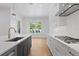 Stylish kitchen featuring a gray island, sleek appliances, and gas cooktop at 4005 W San Rafael St, Tampa, FL 33629