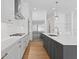 Bright, white kitchen features a gray island and stainless steel appliances and gold hardware at 4005 W San Rafael St, Tampa, FL 33629