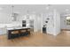 Modern kitchen with stainless steel appliances, an island with barstool seating, and light hardwood floors at 4005 W San Rafael St, Tampa, FL 33629