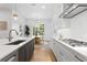 Elegant kitchen featuring white cabinets, an island with bar stool seating, and hardwood floors at 4005 W San Rafael St, Tampa, FL 33629