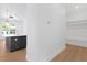 Modern kitchen island with dark cabinetry and pendant lighting near a hall tree at 4005 W San Rafael St, Tampa, FL 33629