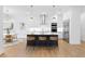 Open-concept kitchen features stainless steel appliances, an island with barstool seating, and hardwood floors at 4005 W San Rafael St, Tampa, FL 33629
