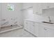 New laundry room with white cabinets, quartz countertop, and sink at 4005 W San Rafael St, Tampa, FL 33629