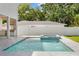 Backyard with a private pool and spa with outdoor kitchen and white privacy fence at 4005 W San Rafael St, Tampa, FL 33629