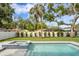 Backyard view of the pool and integrated jacuzzi with grass and landscaping at 4005 W San Rafael St, Tampa, FL 33629