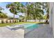 Backyard view of the pool and integrated jacuzzi with grass and landscaping at 4005 W San Rafael St, Tampa, FL 33629