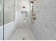 Walk-in shower with marble walls and gold fixtures at 4005 W San Rafael St, Tampa, FL 33629