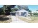 Quaint house exterior with a gated entrance and well-maintained lawn at 10008 N Jasmine Ave, Tampa, FL 33612