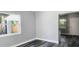 Bright living room with grey walls and wood-look floors at 10008 N Jasmine Ave, Tampa, FL 33612