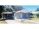 Newly renovated home with carport and front porch at 10008 N Jasmine Ave, Tampa, FL 33612